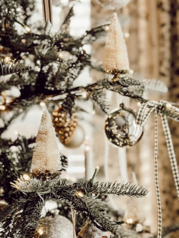 ornaments on a tree made from candlestick holders