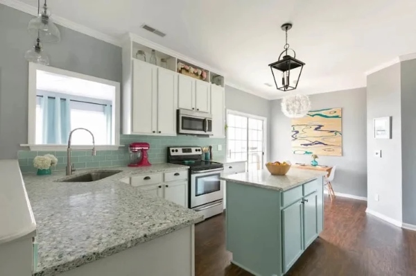 Freshly painted light blue cabinets in bright kitchen