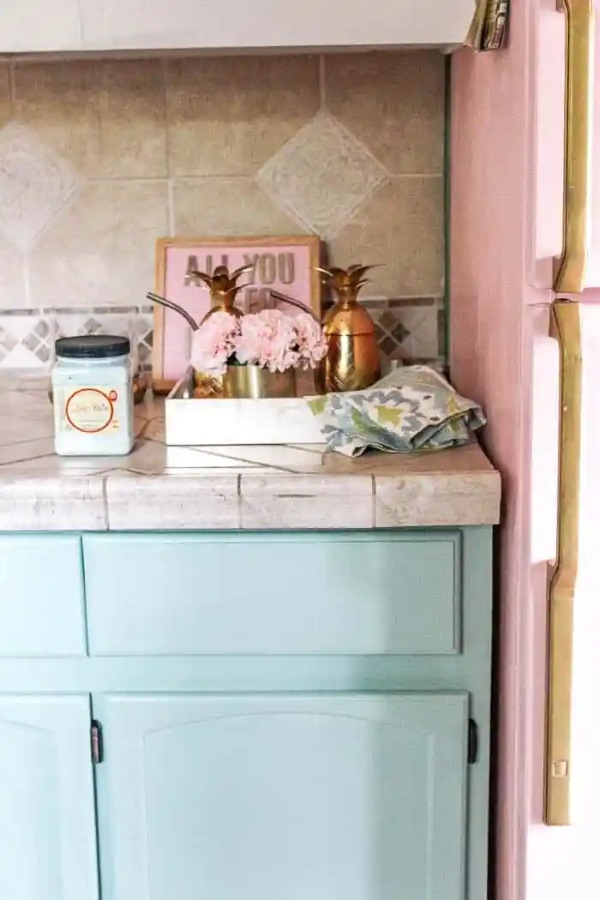 Peel-and-Stick Backsplash in kitchen with blue cabinets and beige countertop