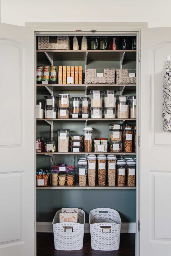 Organized Kitchen Pantry with a variety of shelves, jars and containers