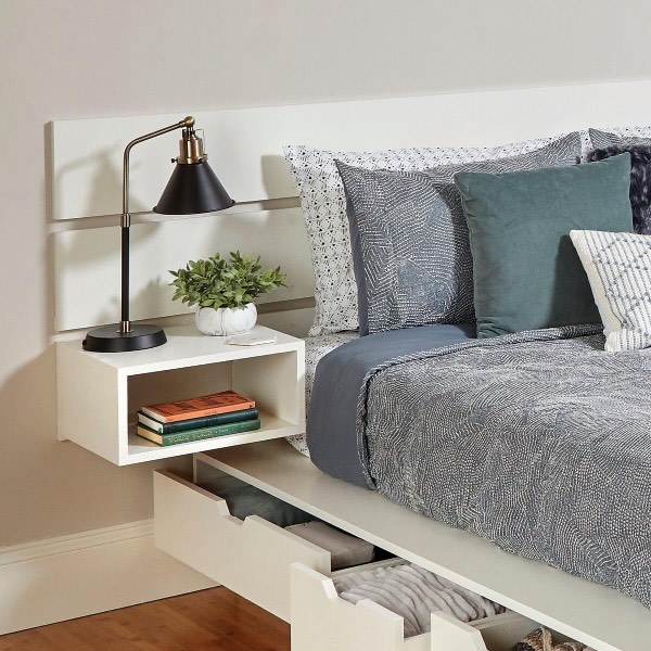 head of bed showing storage drawers underneath and attached floating nightstands