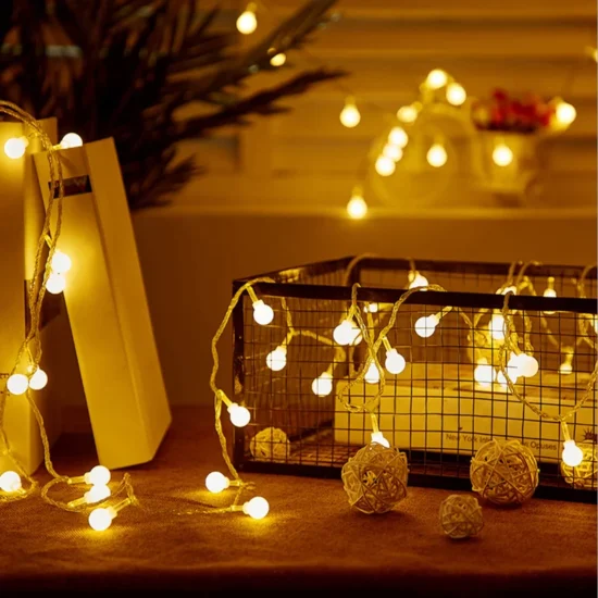 mini string lights draped over some small home decor